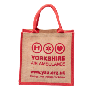 Jute shopping back with red handles and trip and a red logo on the front