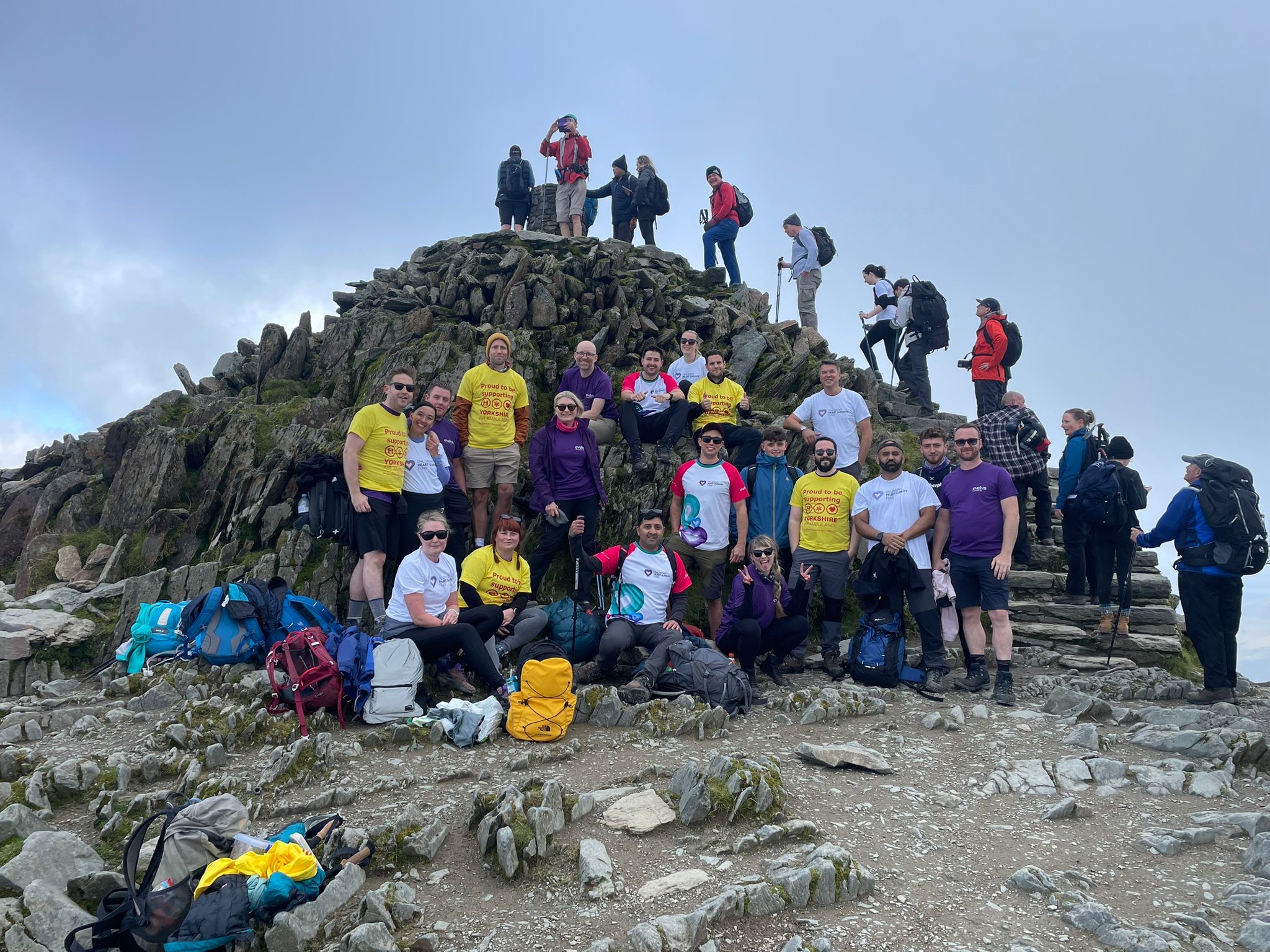 Image shows people climbing a mountain.