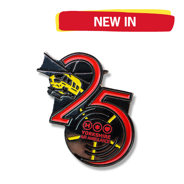 A metal pin badge made up of the numbers 2 and 5, a yellow helicopter and the Yorkshire Air Ambulance logo on a white background, with a graphic in the top left which says 'NEW IN'