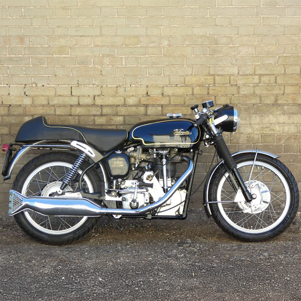 A motorbike in front of a wall.